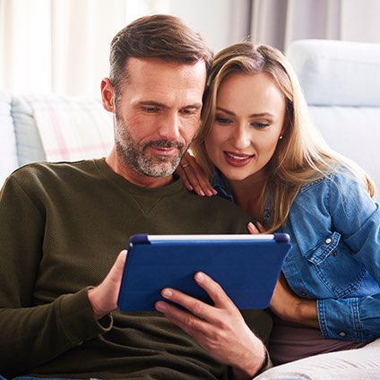 Couple looking at tablet together.