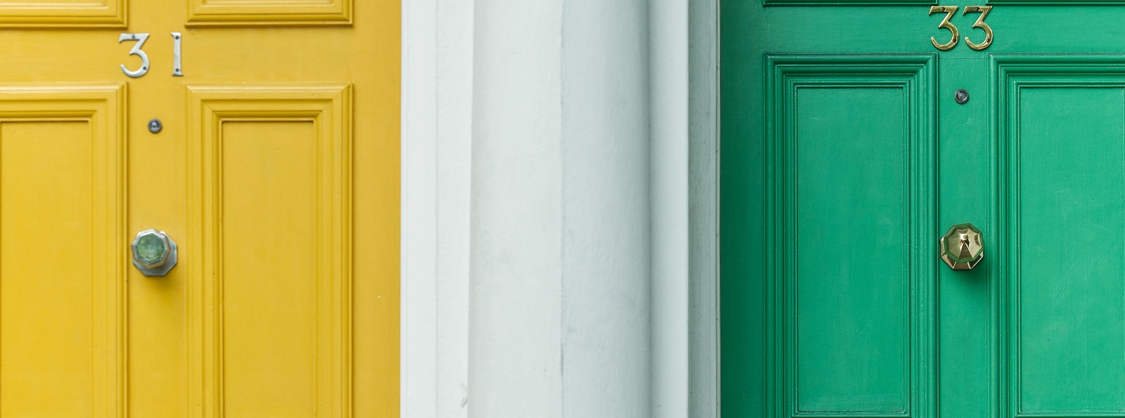 Yellow and Green front doors of a home